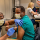 Nurse practitioner Robert McCary receives the Pfizer-BioNTech covia-19 vaccine at Sutter Medical Center in Sacramento, California on Dec. 18, 2020.